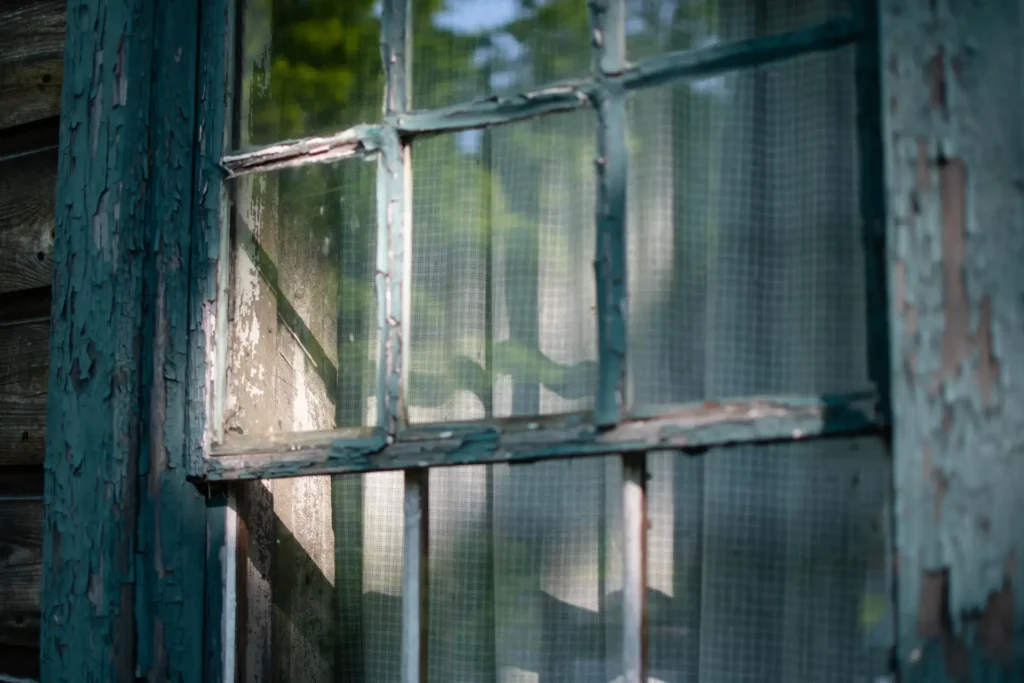 Streak-free clean glass window after professional paint removal service.