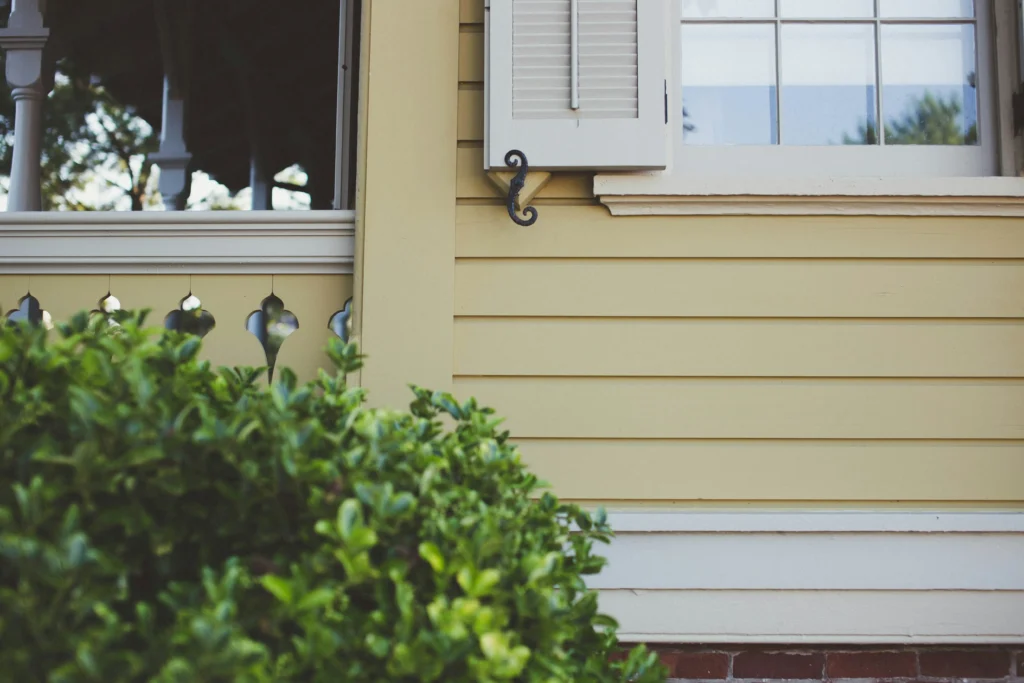 Professional gutter brightening and cleaning to remove vertical black tiger stripes from aluminum gutters.